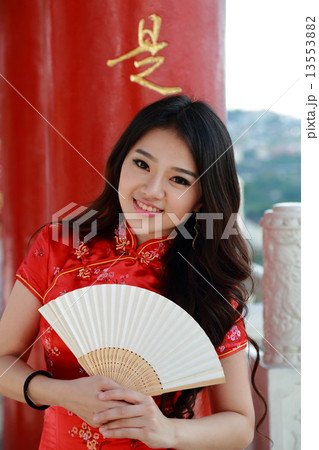 Woman wearing Chinese Chenogsam  at Temple 13553882