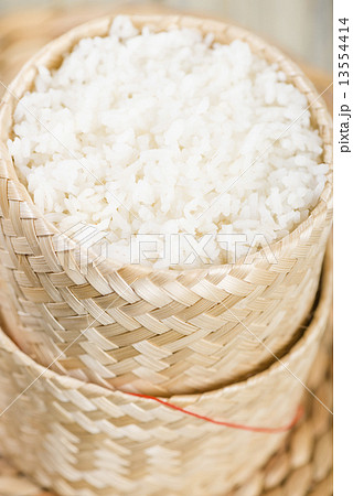 Khao Niao - Sticky rice in a traditional Lao/Thai bamboo basket Khao Niao - Sticky rice in a traditional Lao/Thai bamboo basket 13554414