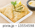 Borek - Middle Eastern spinach and cheese stuffed pastry served with hummus and lemon wedges. 13554598