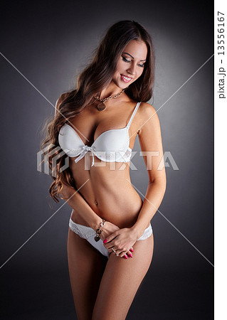 Smiling busty woman posing in white underwear 13556167