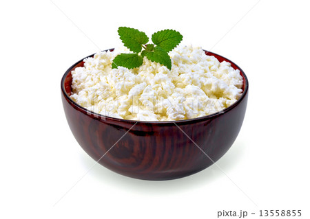 Curd in wooden bowl with mint 13558855