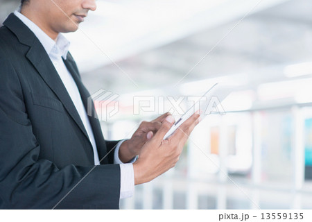 Indian business people using tablet computer 13559135