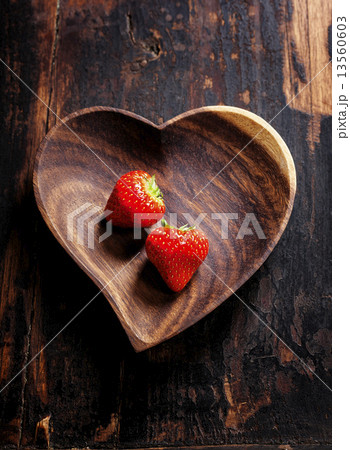 heart shape plate on wooden table 13560603