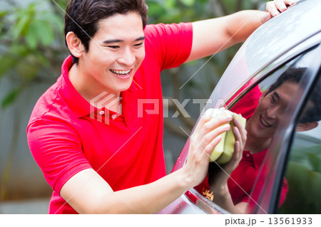 Asian man cleaning and washing car with sponge Asian man cleaning and washing car with sponge 13561933