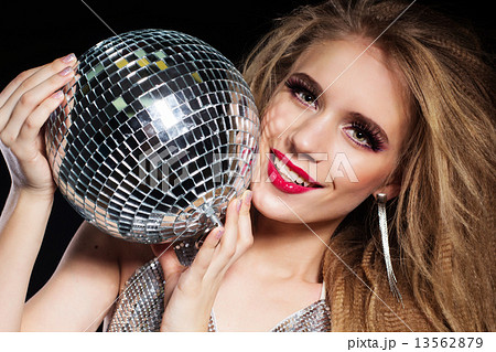 Fashion girl with disco ball over black background 13562879