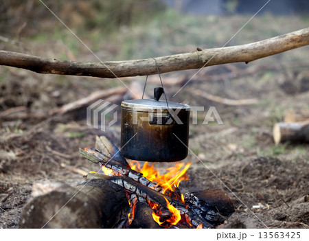 Cooking in sooty cauldron on campfire 13563425