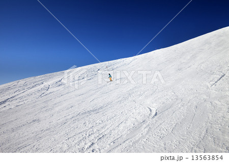 Skier on slope in sun day 13563854