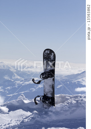 Snowboard in snow on off-piste slope at sun day Snowboard in snow on off-piste slope at sun day 13563862