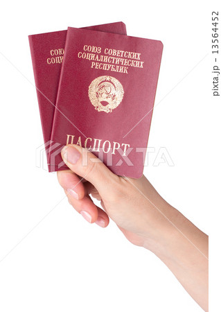 female hand holding pasports of the Soviet Union 13564452
