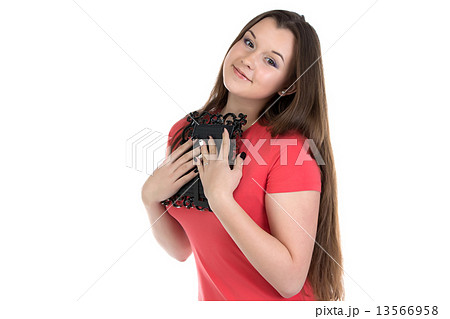 Teenage girl holding photo frame 13566958