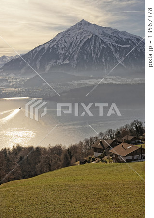 Sunrise in a village over the Thun lake in Swiss Alps in winter 13567378