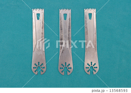 Surgery oscillating saw blades on green cloth. Surgery oscillating saw blades on green cloth. 13568593