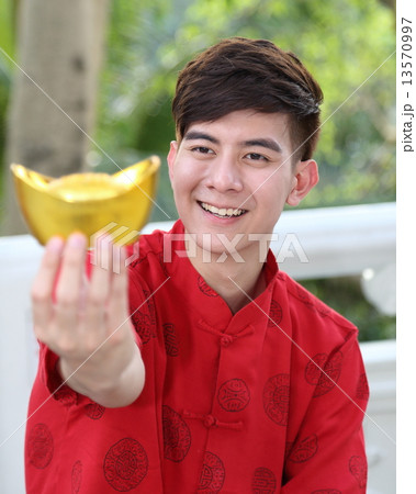 Man in Chinese Chenogsam holding Sycee Focus on FACE 13570997