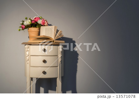 Couch table with flowers and book 13571078