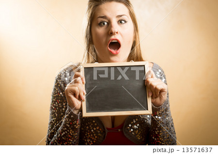 amazed woman holding blank chalkboard in hands amazed woman holding blank chalkboard in hands 13571637