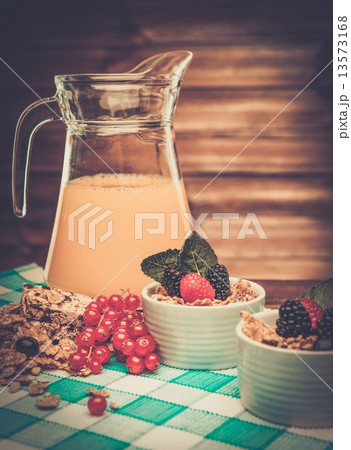 Healthy breakfast with fresh orange juice in wooden rural interior 13573168