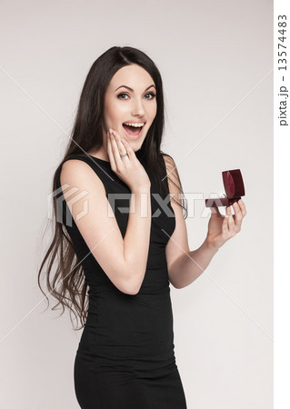 Surpriced woman holding jewelry box Surpriced woman holding jewelry box 13574483