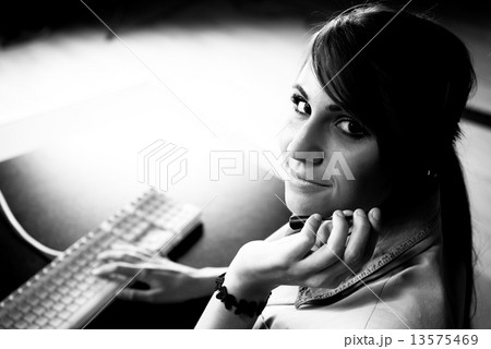Woman sitting at helpdesk Woman sitting at helpdesk 13575469