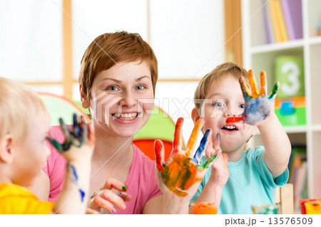 Happy family - mother and sons having fun with paints  13576509