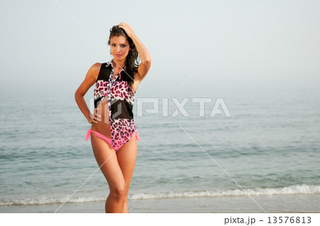Woman with beautiful body on a tropical beach 13576813