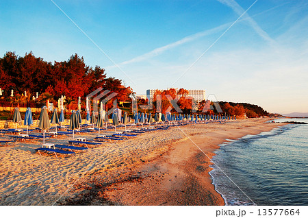 Sunbeds on a beach during sunrise, Halkidiki, Greece Sunbeds on a beach during sunrise, Halkidiki, Greece 13577664