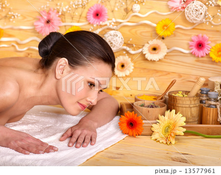 Woman getting herbal ball massage. Woman getting herbal ball massage. 13577961