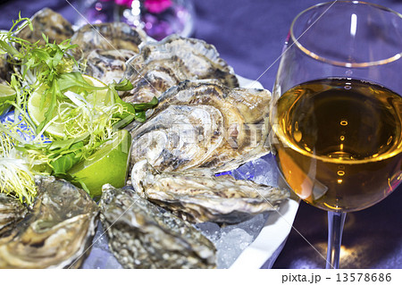 oysters on ice in a dish on a table in a restaurant 13578686