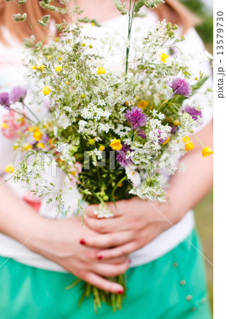 Woman holding wild flowers 13579730