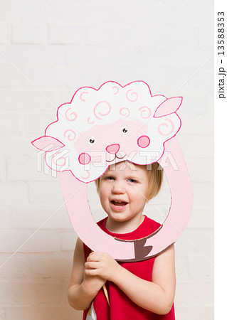 Little girls holding sheep mask on white background 13588353