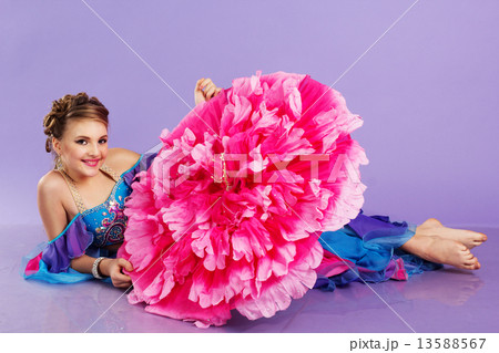 Beautiful belly dancer wearing a purple costume Beautiful belly dancer wearing a purple costume 13588567