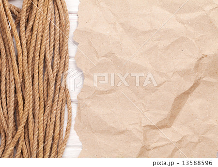 Brown rumpled cardboard paper background with marine rope 13588596