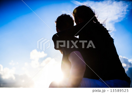 Couple enjoying romantic sunset on beach Couple enjoying romantic sunset on beach 13589525