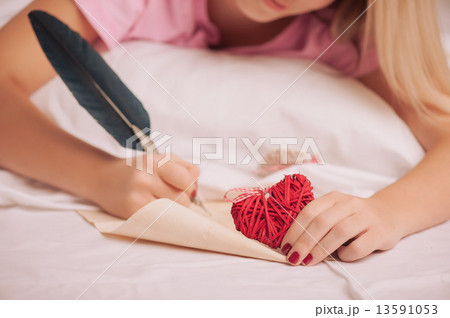 Woman writing love letter with feather pen 13591053
