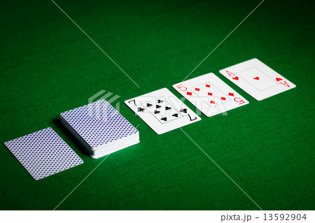 playing cards on green table surface playing cards on green table surface 13592904