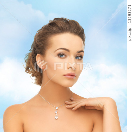 woman wearing shiny diamond pendant 13593271