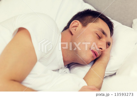 handsome man sleeping in bed 13593273