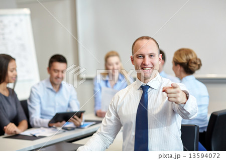 group of smiling businesspeople meeting in office 13594072