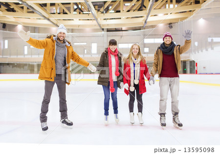 happy friends waving hands on skating rink happy friends waving hands on skating rink 13595098