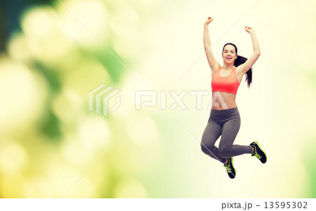 sporty teenage girl jumping in sportswear 13595302