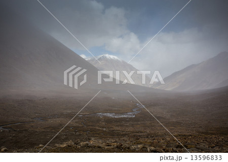 field against the background of distant colorful mountain range field against the background of distant colorful mountain range 13596833