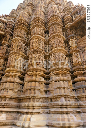 Kamasutra scene on the wall of a Temple in Khajuraho. 13597563