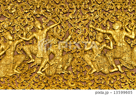 The ramayana epic carved on a wood door inside a temple. Luang P 13599605