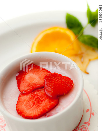 Italian dessert panna cotta on white plate decorated wth orange Italian dessert panna cotta on white plate decorated wth orange 13600061