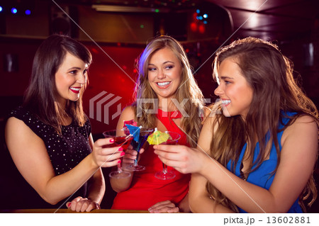 Pretty friends drinking cocktails together Pretty friends drinking cocktails together 13602881