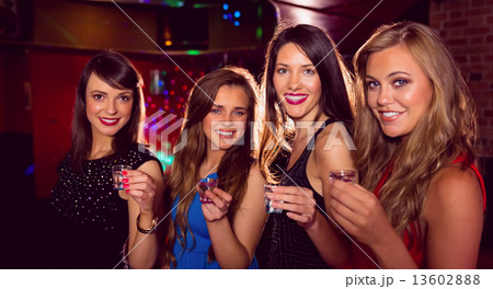 Pretty friends drinking shots together Pretty friends drinking shots together 13602888