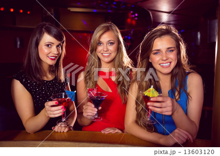 Pretty friends drinking cocktails together Pretty friends drinking cocktails together 13603120