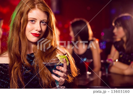 Pretty redhead drinking a cocktail Pretty redhead drinking a cocktail 13603160