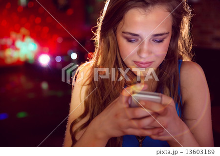Pretty girl texting on her phone Pretty girl texting on her phone 13603189