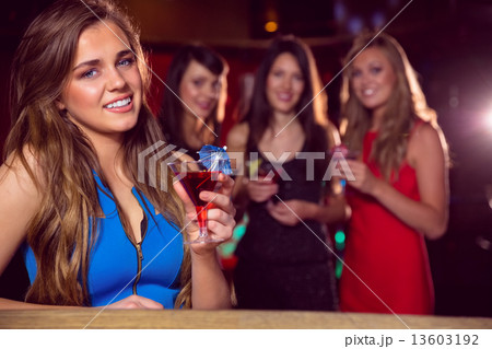 Pretty blonde drinking a cocktail 13603192