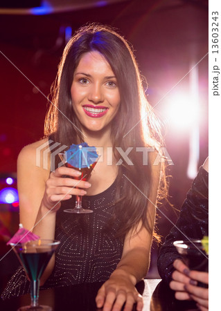 Pretty brunette drinking a cocktail Pretty brunette drinking a cocktail 13603243